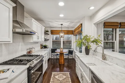 a kitchen with stainless steel appliances granite countertop a refrigerator and a stove