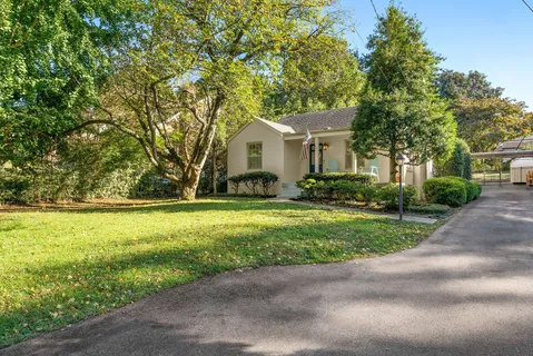 a front view of house with yard and green space