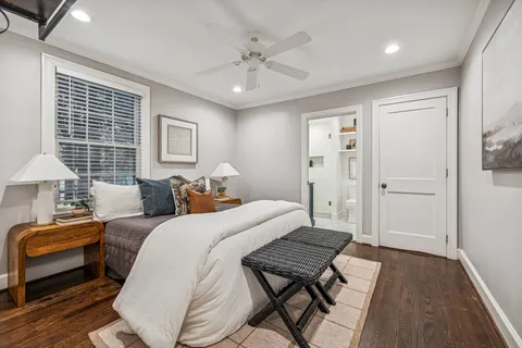 a bedroom with a bed and painting on the wall