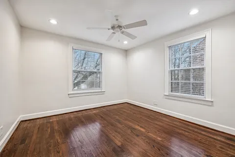 a view of an empty room with wooden floor