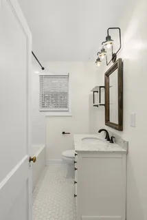 a view of a hallway with wooden floor and entryway