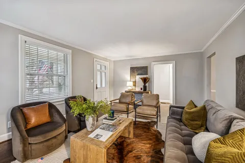 a view of a dining room with furniture and chandelier