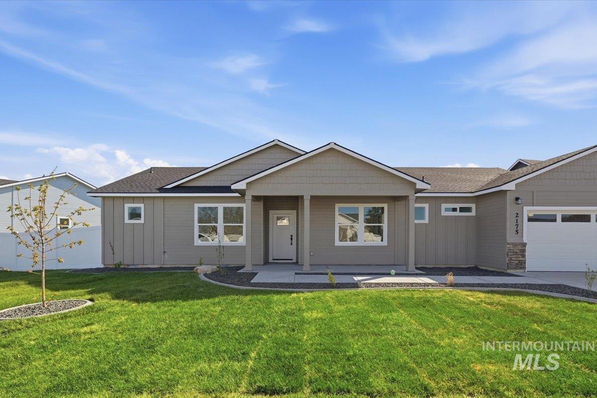 2175 Austin Way Fruitland, ID 83619 - Photo 1 of 30 Single story home with board and batten siding, a porch, and a front yard