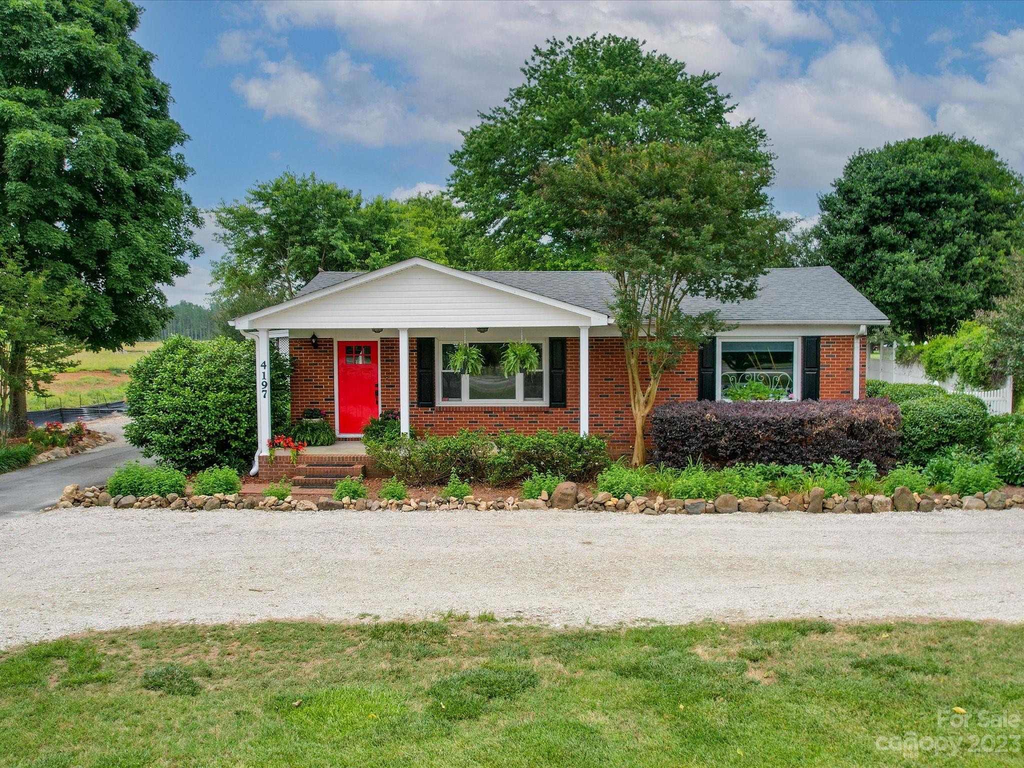 a front view of a house with garden