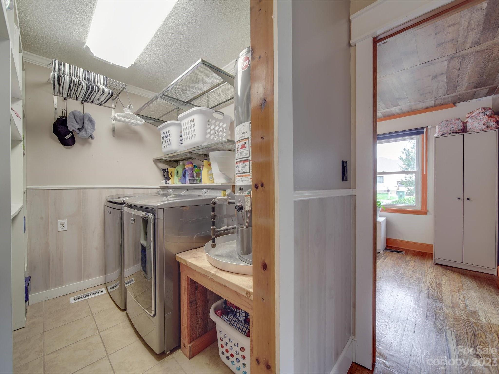 4197 Stallings Road Harrisburg, NC 28075 - Photo 13 of 41 a utility room with cabinets and washer