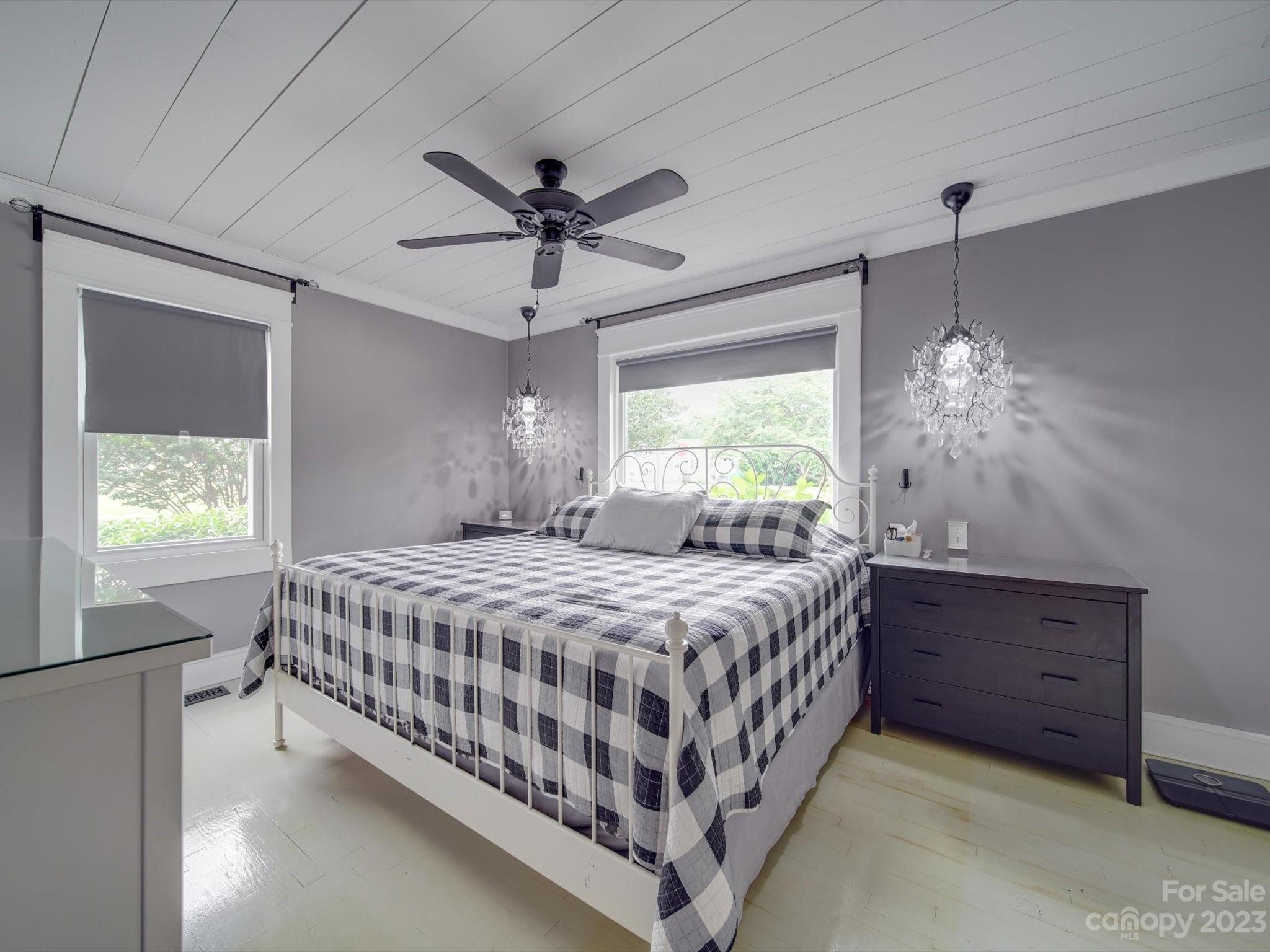 4197 Stallings Road Harrisburg, NC 28075 - Photo 16 of 41 a bedroom with a bed chandelier and a window