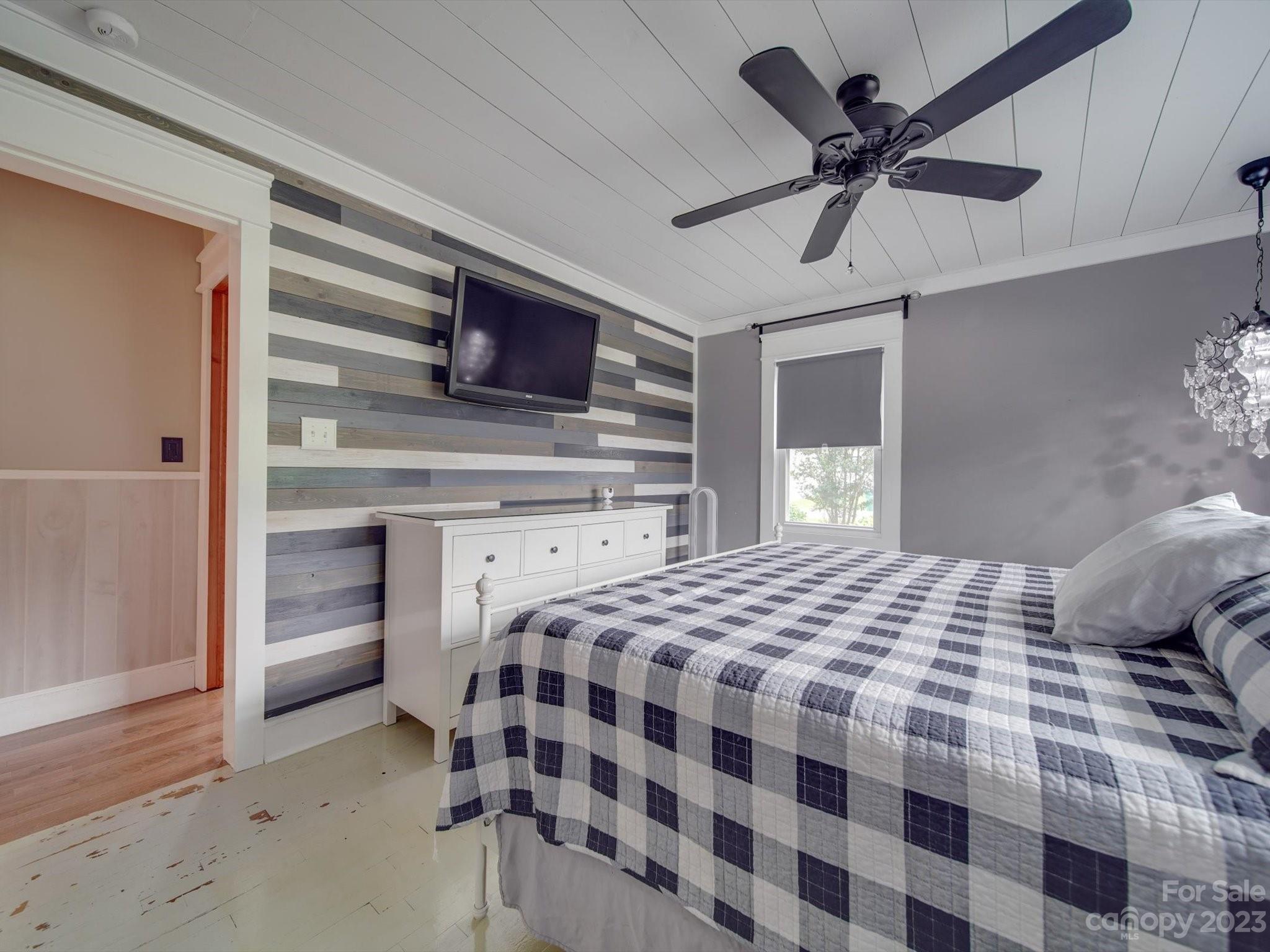 4197 Stallings Road Harrisburg, NC 28075 - Photo 17 of 41 a bedroom with a bed and a television