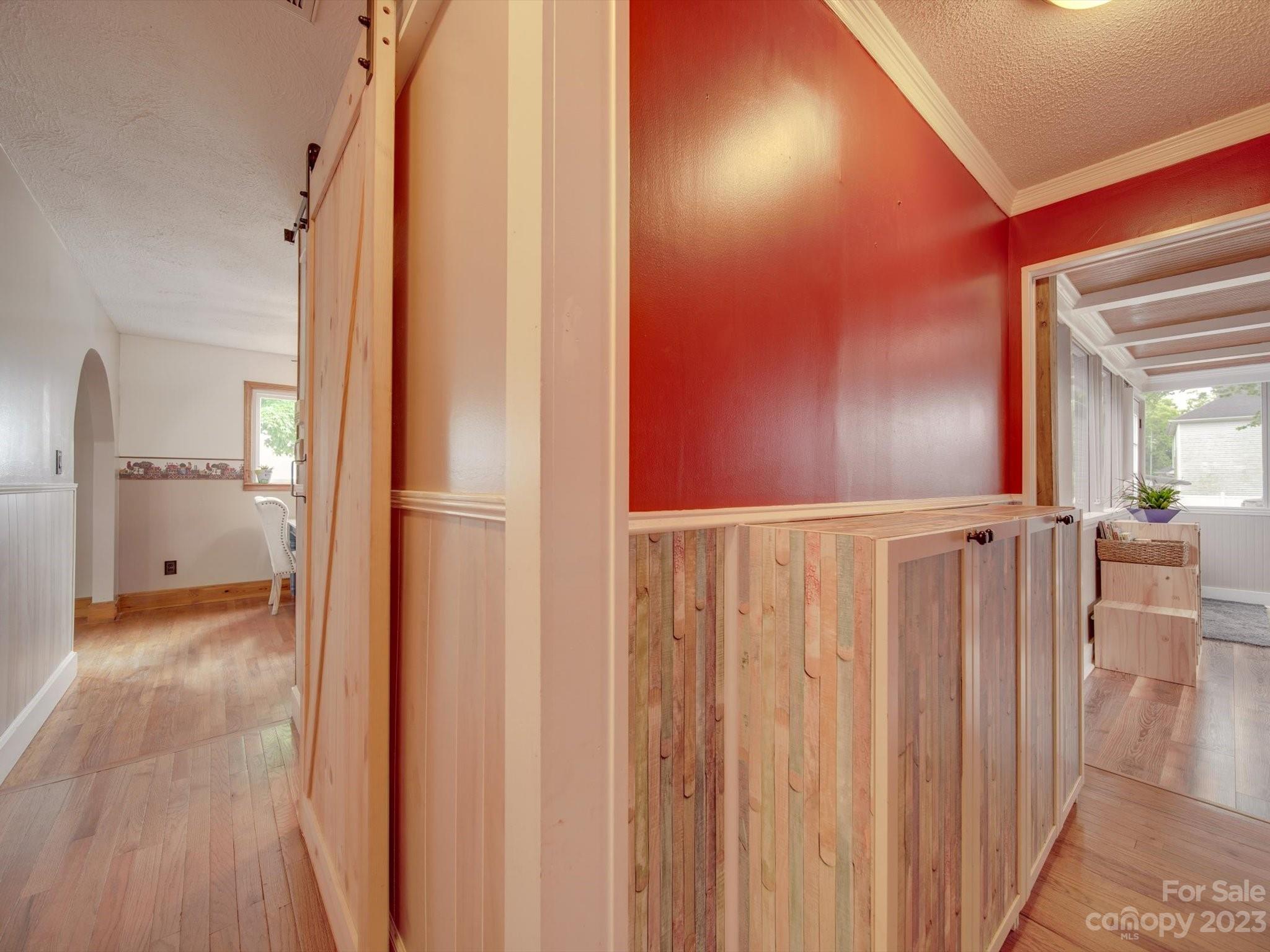 4197 Stallings Road Harrisburg, NC 28075 - Photo 22 of 41 a view of a hallway with wooden floor windows and a bathroom