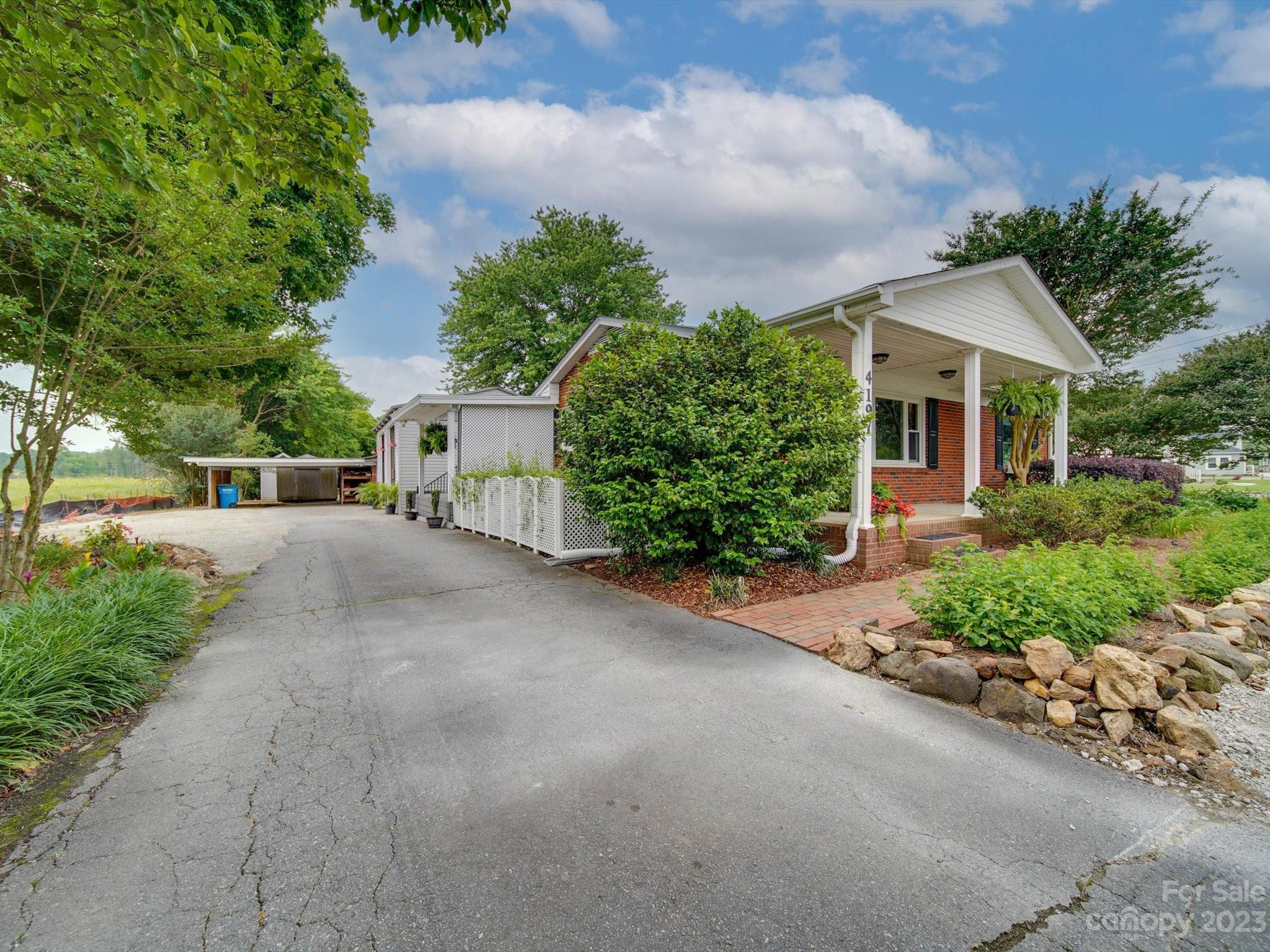 4197 Stallings Road Harrisburg, NC 28075 - Photo 27 of 41 a view of a house with a yard and potted plants