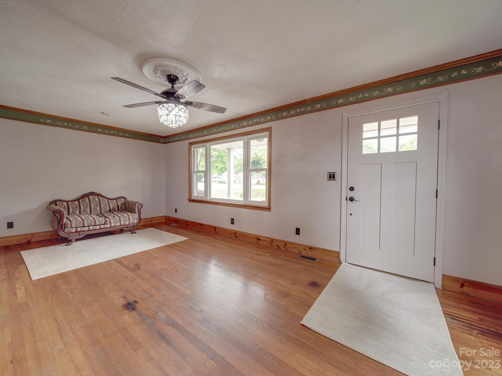 4197 Stallings Road Harrisburg, NC 28075 - Photo 4 of 41 a view of an empty room with window and wooden floor