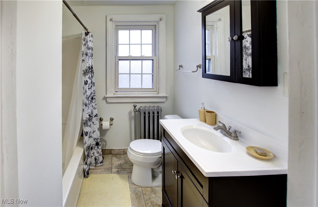 17800 Winslow Road Beachwood, OH 44122 - Photo 20 of 31 Full bathroom featuring vanity, tile patterned flooring, toilet, radiator heating unit, and shower / tub combo
