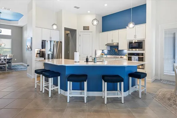 a kitchen with stainless steel appliances granite countertop a stove a microwave and cabinets