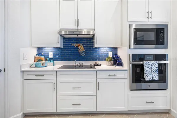 a kitchen with stainless steel appliances kitchen island a refrigerator and a stove