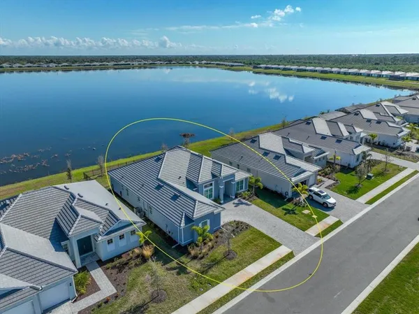 an aerial view of a house with a lake view