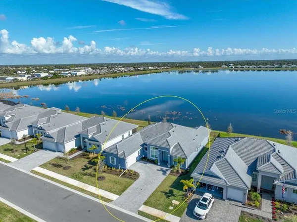 an aerial view of a house with a lake view