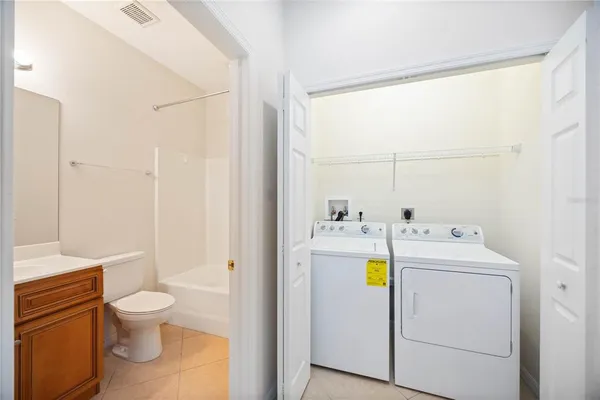a spacious bathroom with a granite countertop sink mirror and