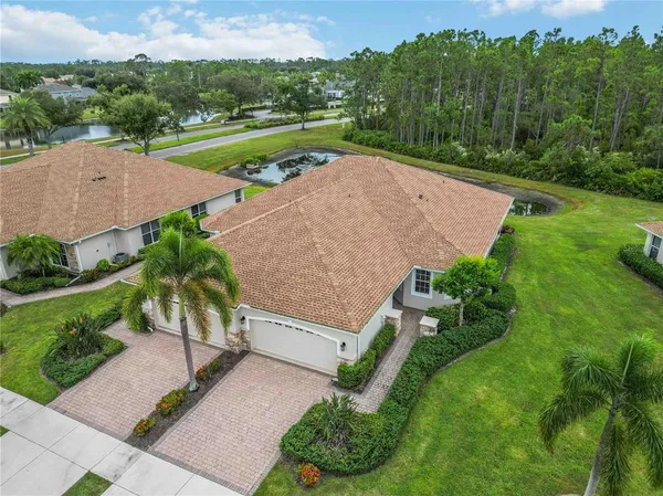 an aerial view of residential houses with outdoor space and street view