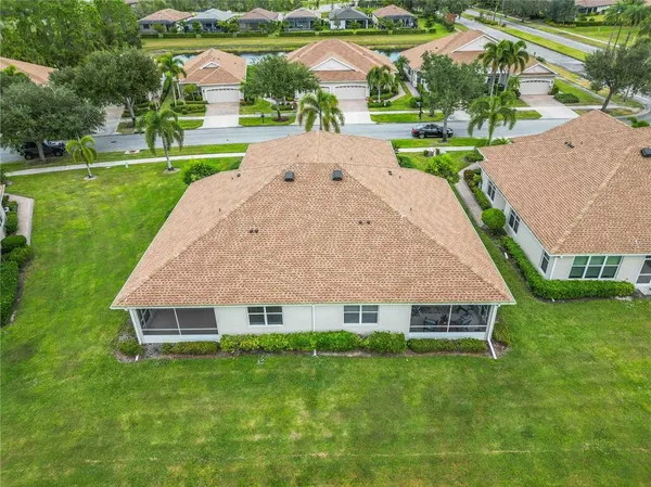 an aerial view of a house with swimming pool garden and outdoor seating