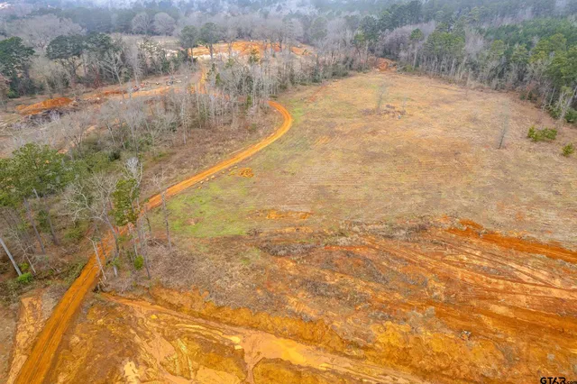a living room with furniture a dining table and a chandelier