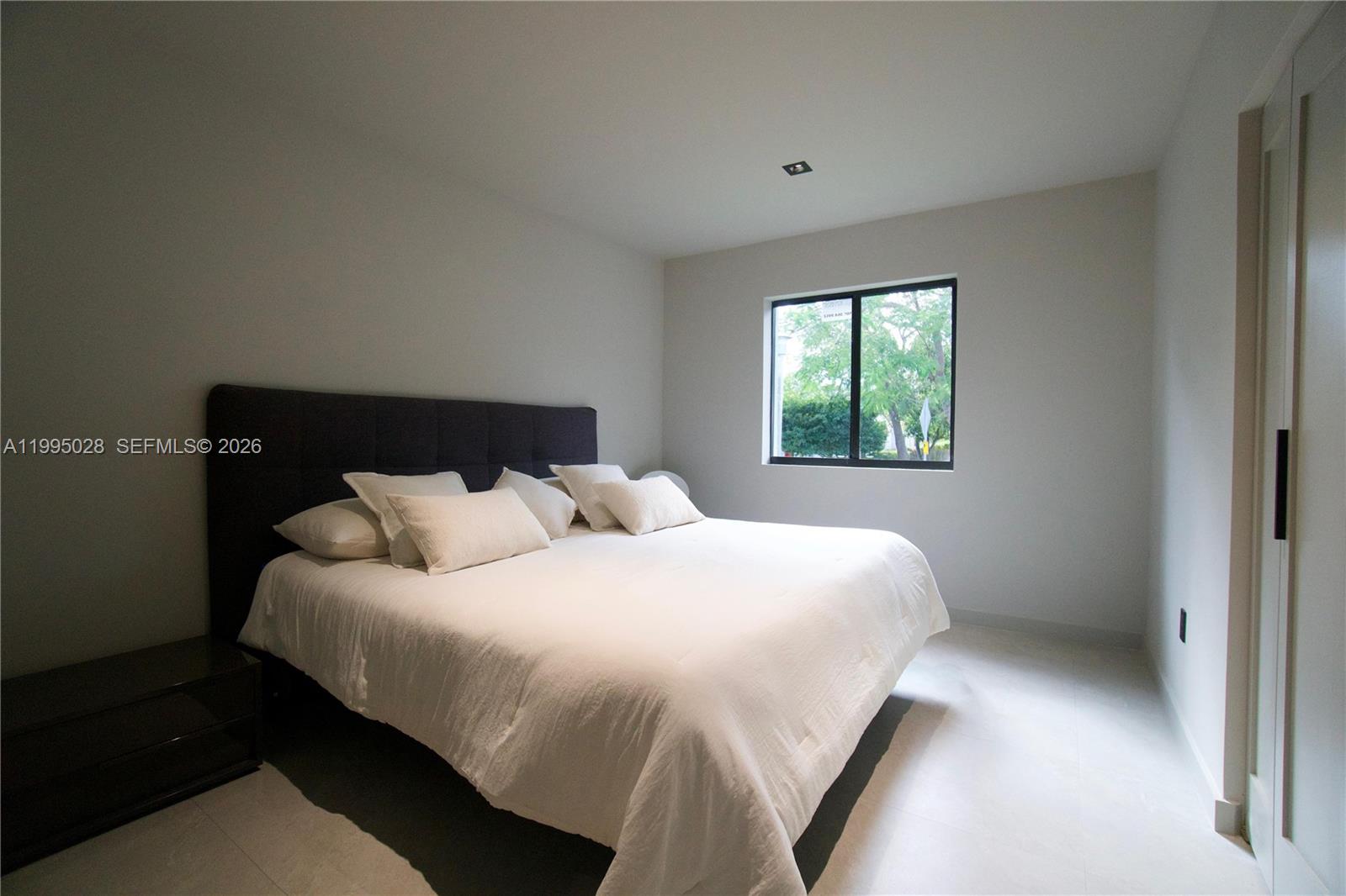 2155 Southwest 25th Terrace Miami, FL 33133 - Photo 11 of 13 a bedroom with a bed and a window
