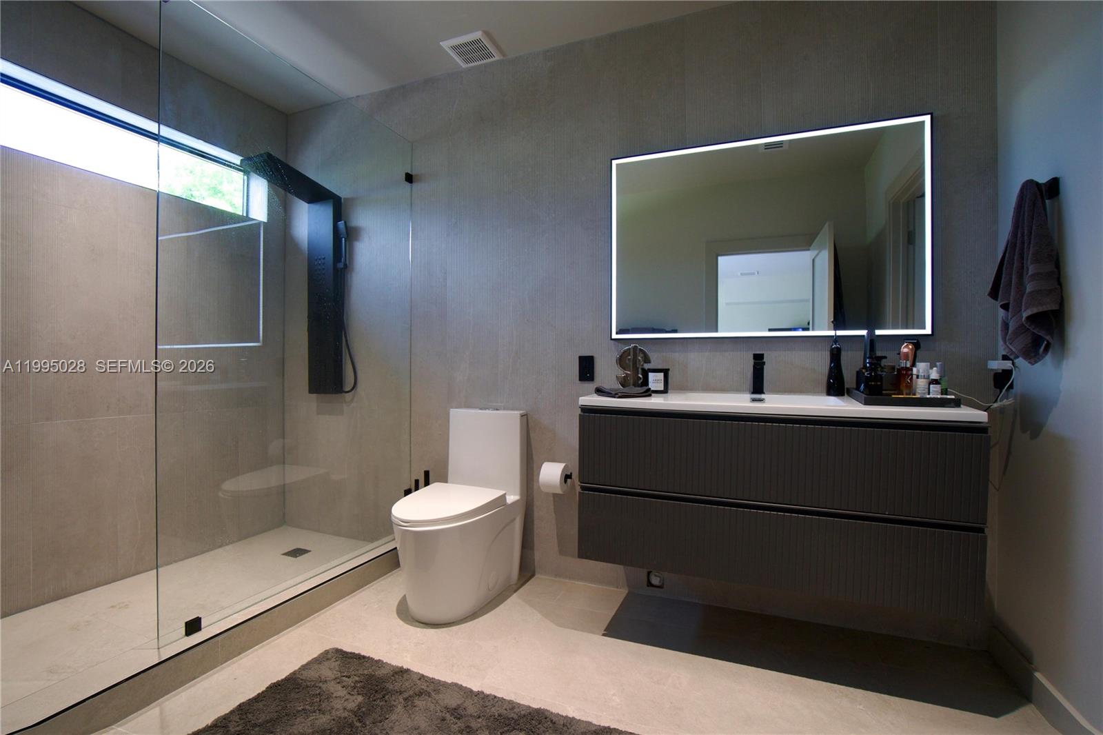 2155 Southwest 25th Terrace Miami, FL 33133 - Photo 12 of 13 a bathroom with a toilet sink and mirror