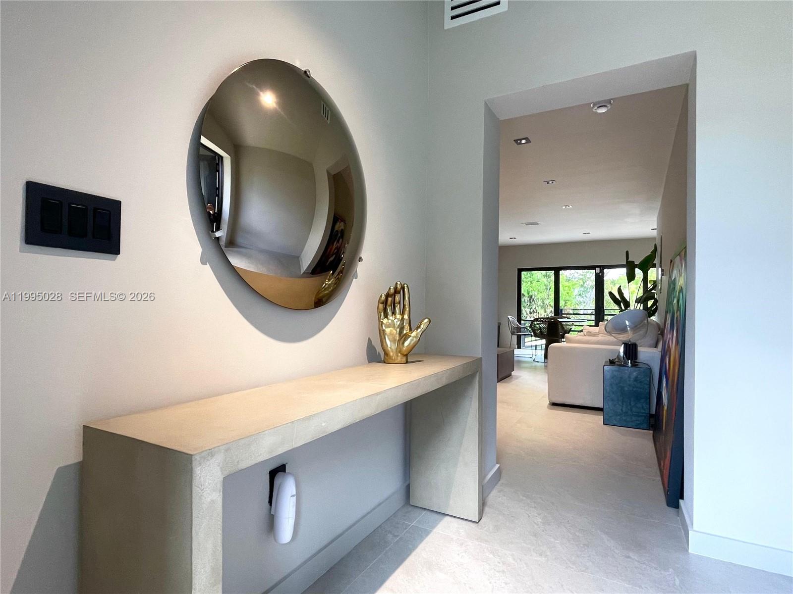 2155 Southwest 25th Terrace Miami, FL 33133 - Photo 7 of 13 a view of living room with furniture and a mirror
