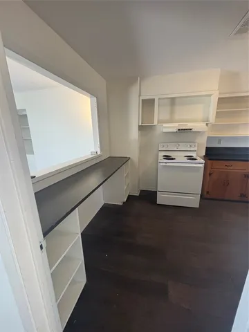 a kitchen with white cabinets and a stove