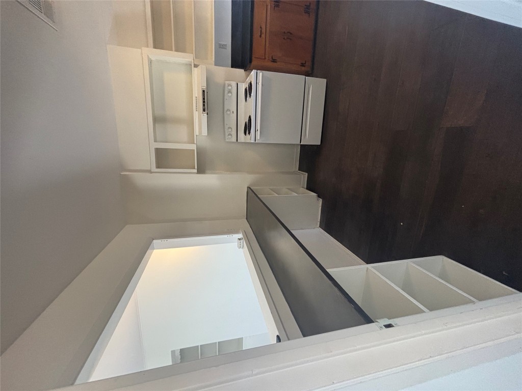 2324 Hartford Road Austin, TX 78703 - Photo 4 of 20 a kitchen with white cabinets and a stove