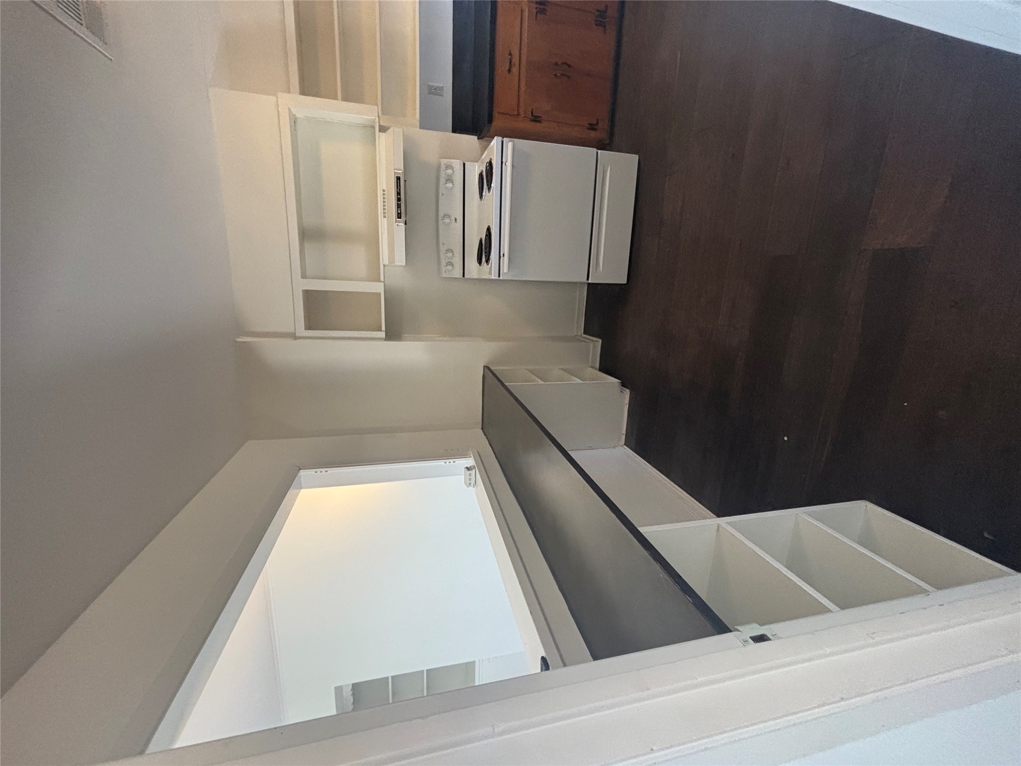 2324 Hartford Road Austin, TX 78703 - Photo 4 of 20 a kitchen with white cabinets and a stove