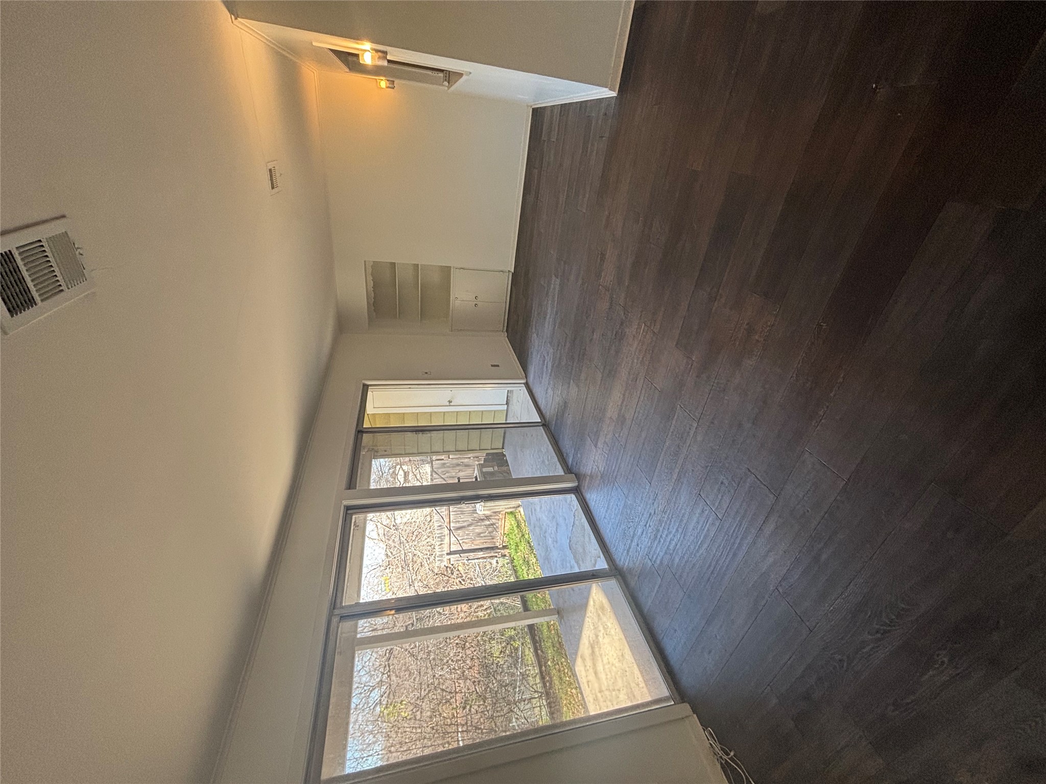 2324 Hartford Road Austin, TX 78703 - Photo 7 of 20 an empty room with wooden floor and windows