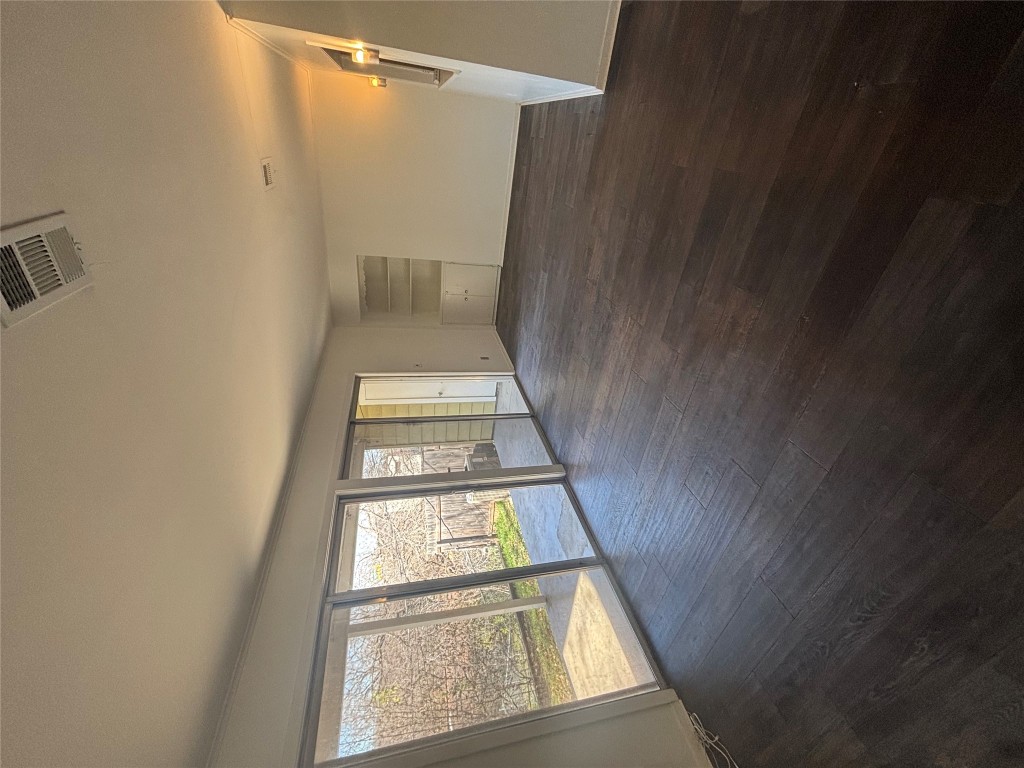 2324 Hartford Road Austin, TX 78703 - Photo 7 of 20 an empty room with wooden floor and windows