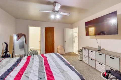 a bedroom with furniture and flat screen tv