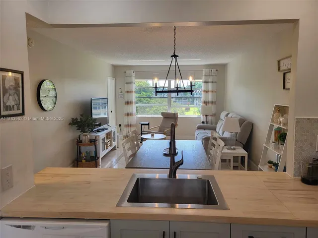 a view of living room with furniture and chandelier