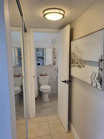 a bathroom with a toilet sink and shower