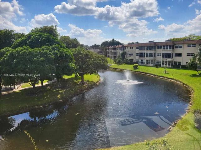 a view of a swimming pool with a yard