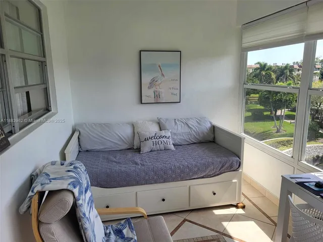 a living room with furniture and a floor to ceiling window