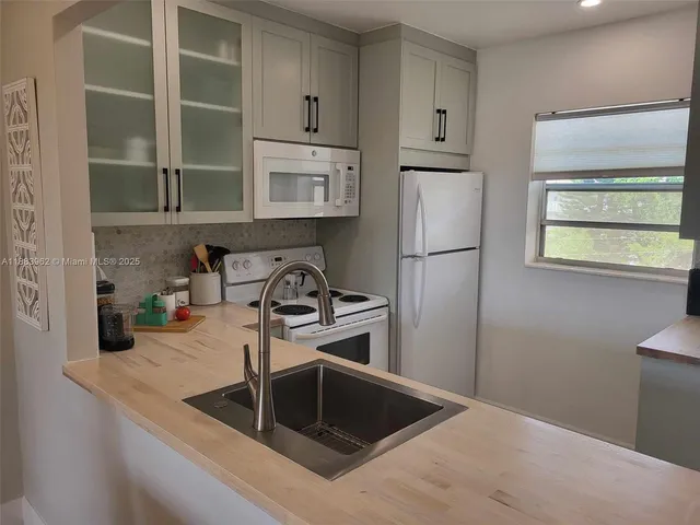 a kitchen with refrigerator and window