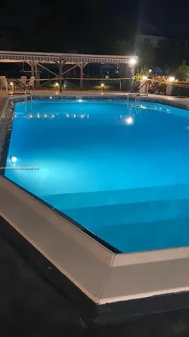 a view of swimming pool with outdoor seating