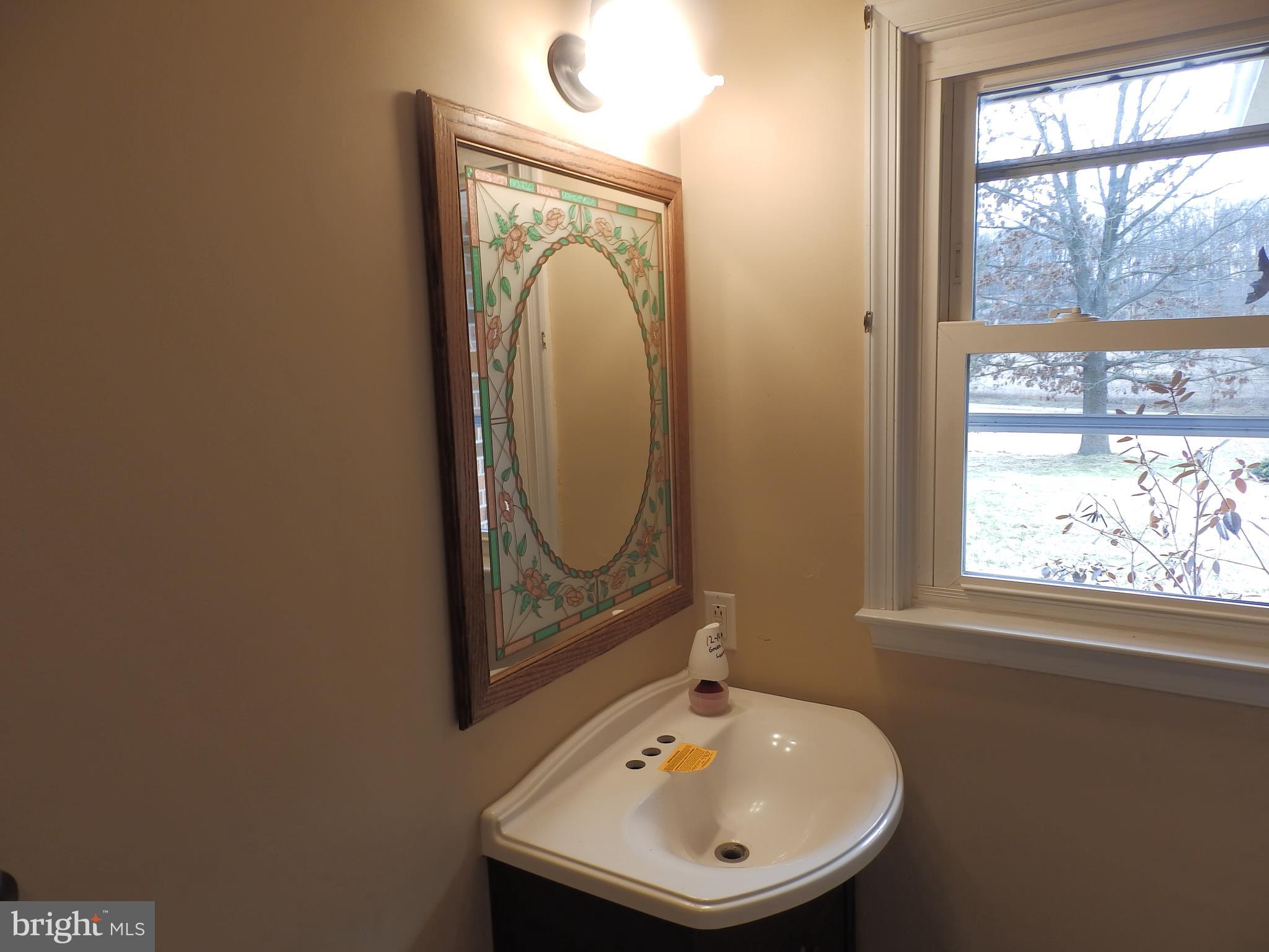 3395 Weldon Road New Windsor, MD 21776 - Photo 21 of 34 a bathroom with a sink a mirror and a window