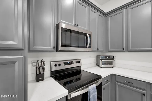 a kitchen with stainless steel appliances a stove a microwave and cabinets