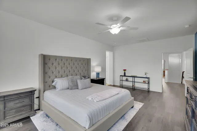 a bedroom with a bed and a chandelier