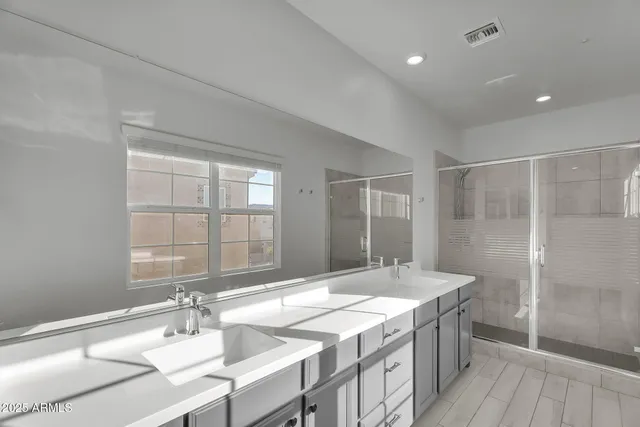 a bathroom with a granite countertop sink a toilet and shower