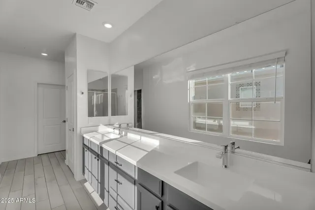 a bathroom with a double vanity sink and a bathtub