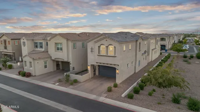 an aerial view of a house with a garden and parking space