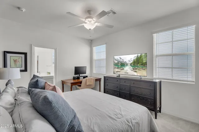 a bedroom with a large bed and a large window