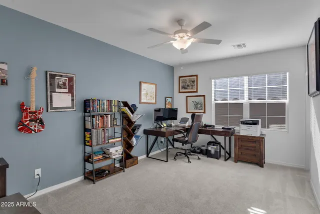 a view of a workspace with furniture and a bookshelf