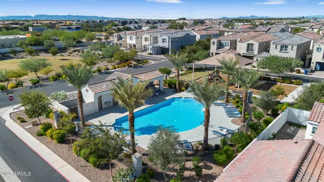an aerial view of a house with a yard and lake view