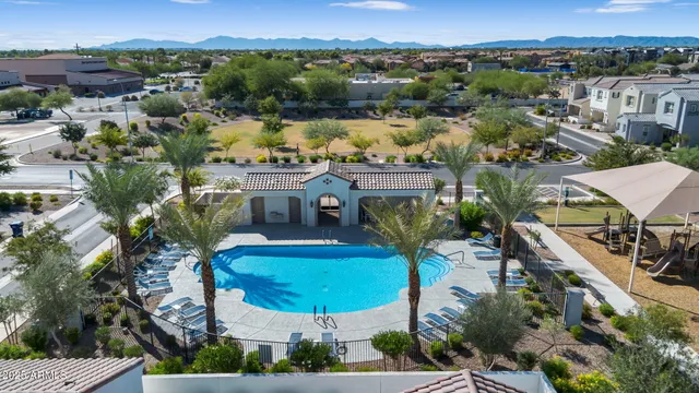 an aerial view of residential houses with outdoor space and swimming pool