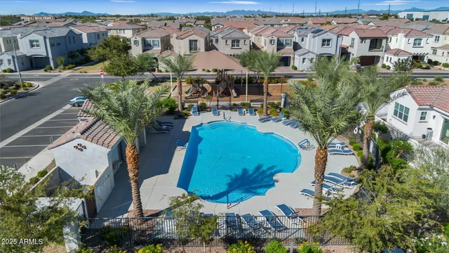 an aerial view of residential houses with outdoor space and parking