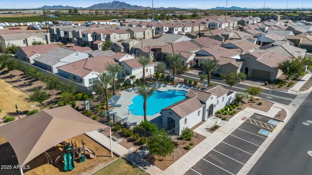an aerial view of residential houses with outdoor space and ocean view